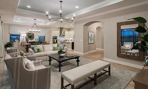 This is an example of a mid-sized transitional open concept family room in Miami with beige walls, light hardwood floors, no fireplace, beige floor and a freestanding tv.