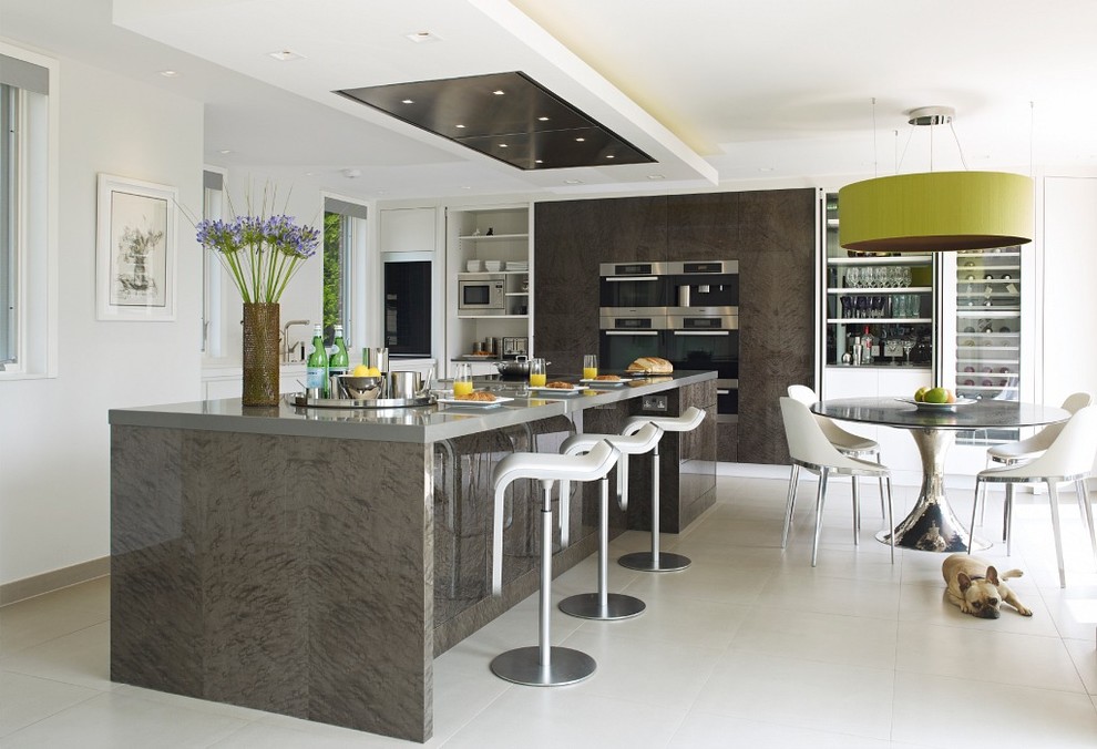 This is an example of a large contemporary u-shaped eat-in kitchen in Surrey with a peninsula.