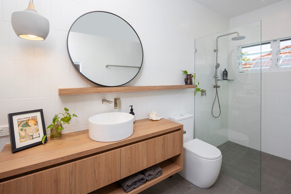 Mid-sized contemporary bathroom in Brisbane with light wood cabinets, an open shower, white walls, wood benchtops, grey floor, an open shower and a floating vanity.