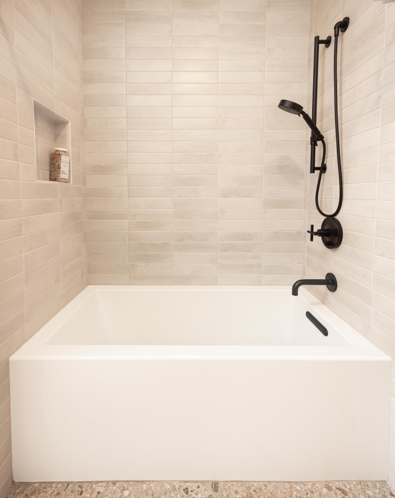Example of a mid-sized mountain style kids' gray tile and porcelain tile terrazzo floor, gray floor and double-sink alcove bathtub design with shaker cabinets, medium tone wood cabinets, a one-piece toilet, beige walls, an undermount sink, quartz countertops, gray countertops, a niche and a freestanding vanity