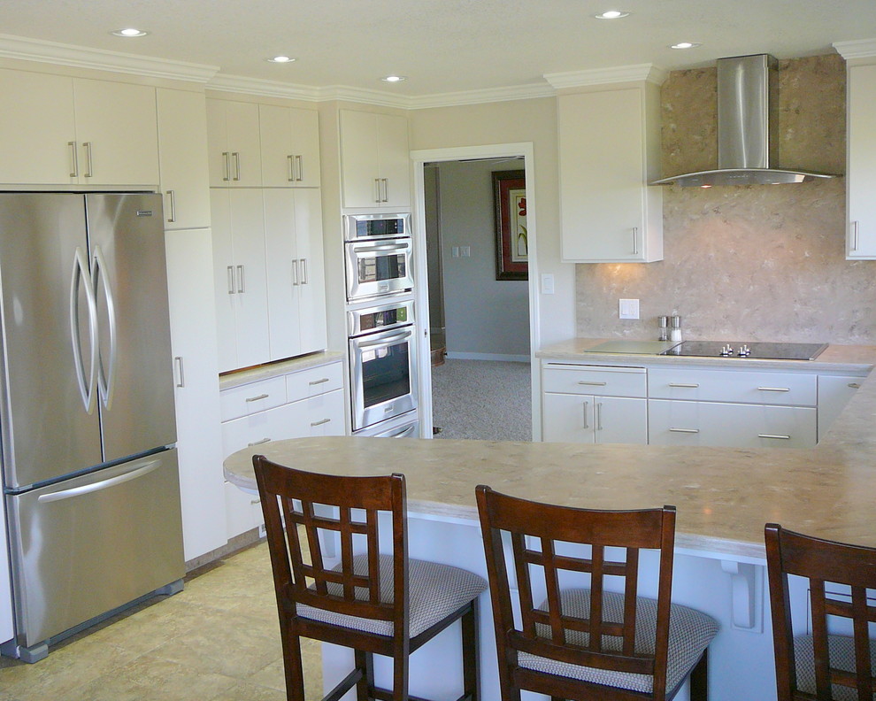 Kitchen - transitional porcelain tile kitchen idea in Sacramento with an undermount sink, flat-panel cabinets, white cabinets, solid surface countertops, beige backsplash and stainless steel appliances