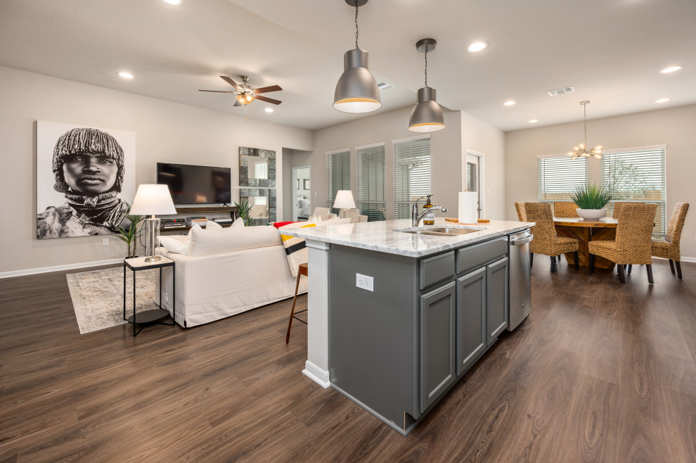 Large arts and crafts single-wall vinyl floor and brown floor open concept kitchen photo in Austin with an undermount sink, shaker cabinets, gray cabinets, granite countertops, gray backsplash, subway tile backsplash, stainless steel appliances, an island and white countertops
