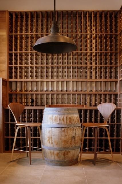Mid-sized arts and crafts wine cellar in Los Angeles with ceramic floors and storage racks.
