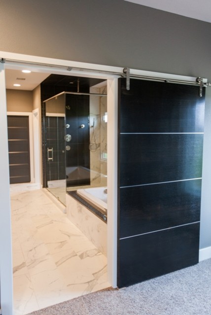 Inspiration for a large modern master stone tile marble floor drop-in bathtub remodel with open cabinets, dark wood cabinets, beige walls, a vessel sink and granite countertops