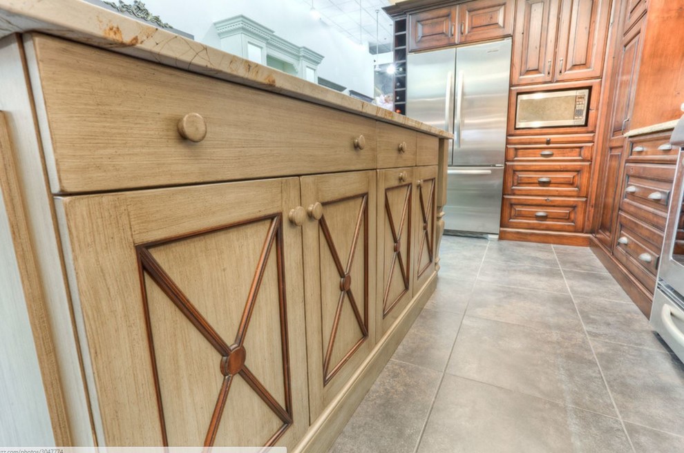 Inspiration for a large rustic u-shaped porcelain tile eat-in kitchen remodel in Toronto with an undermount sink, raised-panel cabinets, brown cabinets, quartz countertops, beige backsplash, stainless steel appliances and an island
