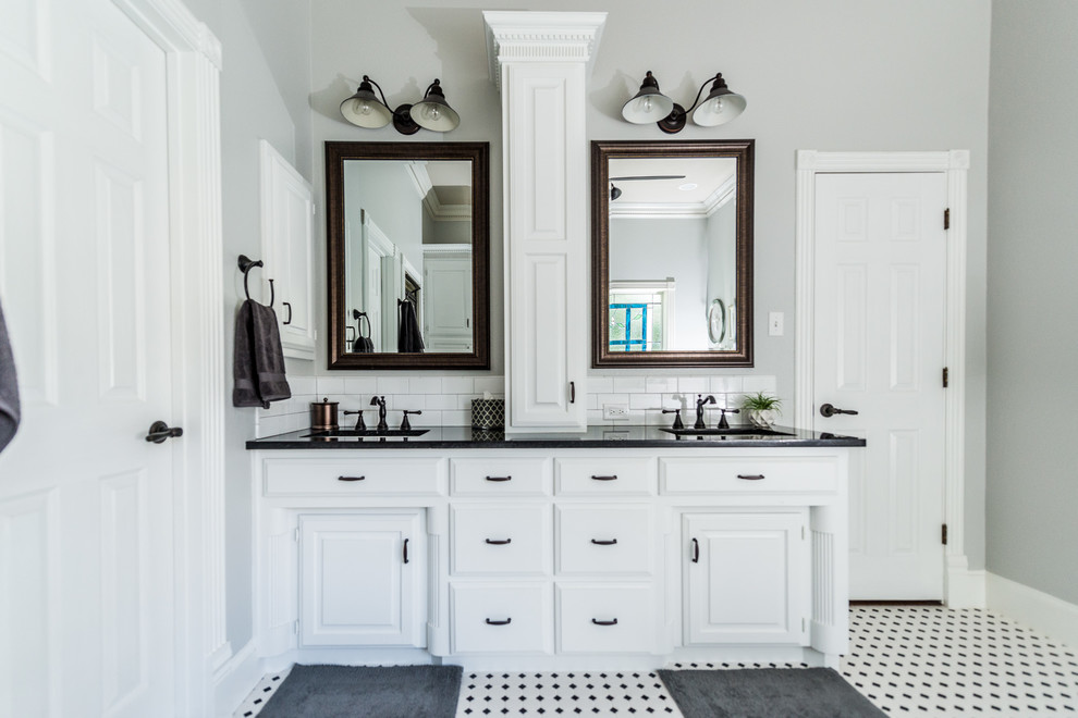Design ideas for a mid-sized country bathroom in Dallas with raised-panel cabinets, white cabinets, a drop-in tub, black and white tile, ceramic tile, grey walls, dark hardwood floors, an undermount sink, granite benchtops and with a sauna.