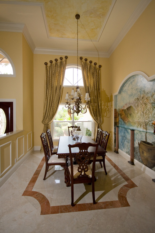 Photo of a tropical dining room in Miami with marble floors and beige floor.
