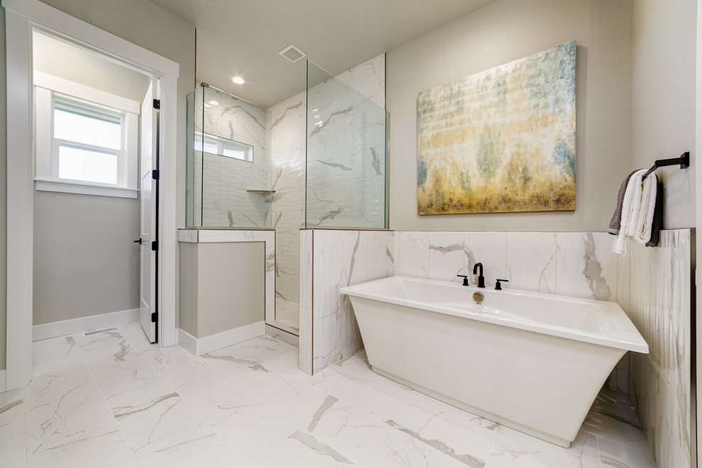 Photo of a mid-sized arts and crafts master bathroom in Boise with recessed-panel cabinets, medium wood cabinets, a freestanding tub, a corner shower, a two-piece toilet, white tile, marble, grey walls, marble floors, an undermount sink, engineered quartz benchtops, white floor, a hinged shower door and white benchtops.