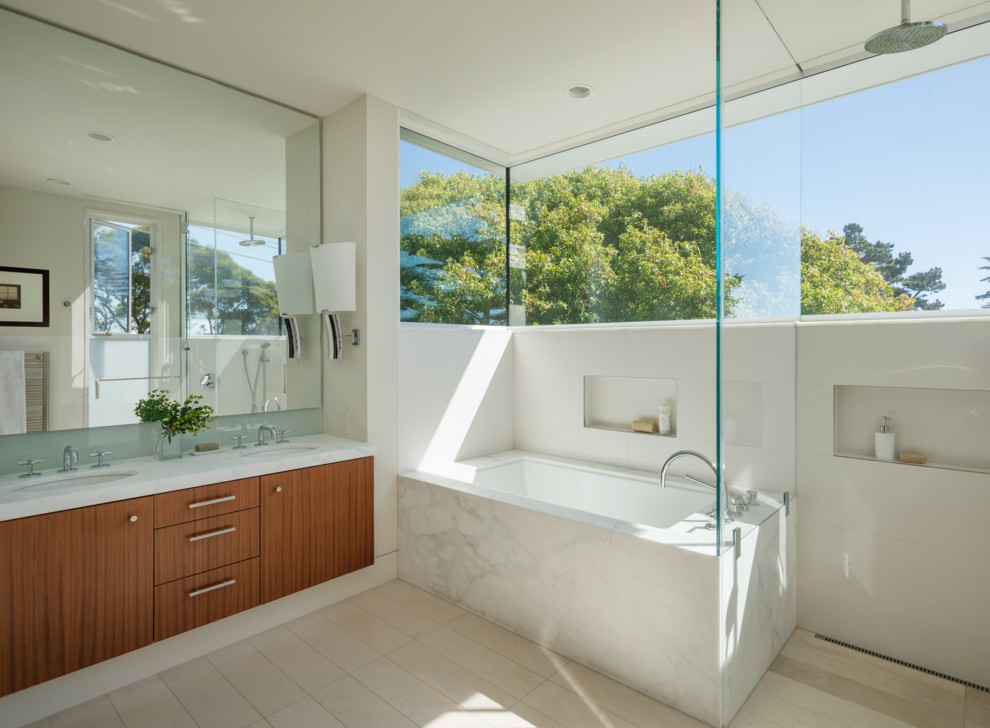 Inspiration for a contemporary bathroom in San Francisco with flat-panel cabinets, medium wood cabinets and an alcove tub.