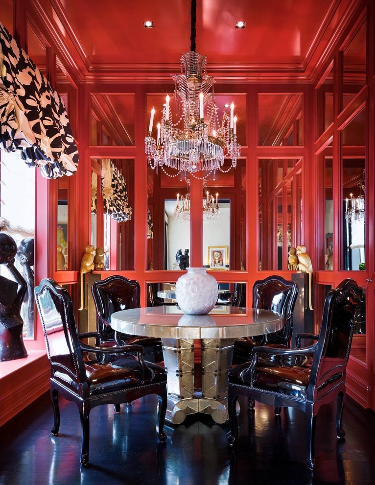 Contemporary separate dining room in New York with red walls, no fireplace and black floor.