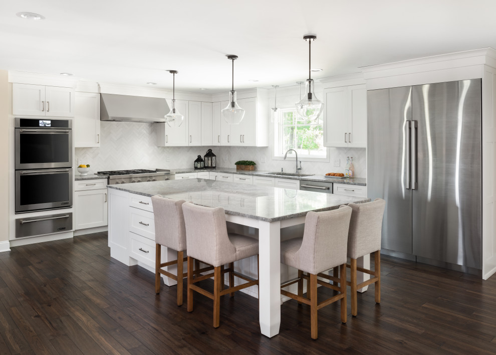 Example of a large transitional dark wood floor eat-in kitchen design in New York with an undermount sink, shaker cabinets, granite countertops, white backsplash, marble backsplash, stainless steel appliances, an island and gray countertops