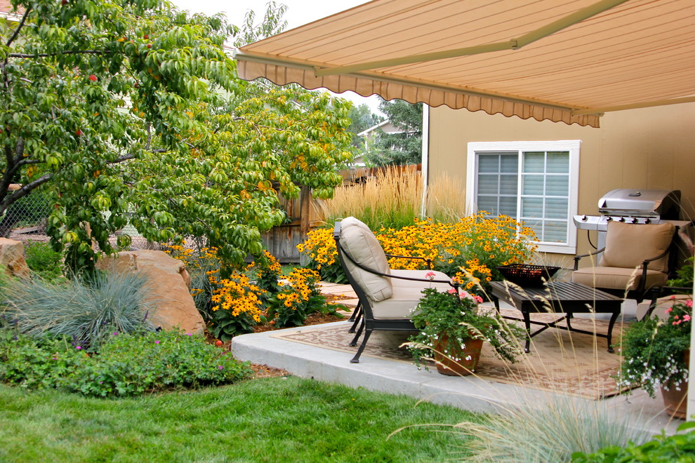 Inspiration for a contemporary patio in Denver with an awning.