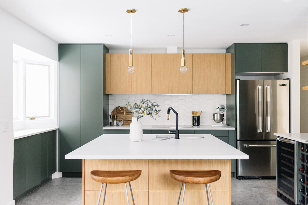 Photo of a scandinavian kitchen in Edmonton with an undermount sink, flat-panel cabinets, green cabinets, white splashback, stainless steel appliances, concrete floors, with island, grey floor and white benchtop.
