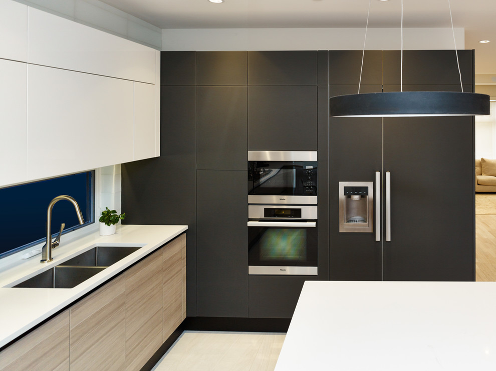Design ideas for a contemporary u-shaped kitchen in Vancouver with an undermount sink, flat-panel cabinets, quartz benchtops, white splashback, glass tile splashback, panelled appliances, ceramic floors and with island.