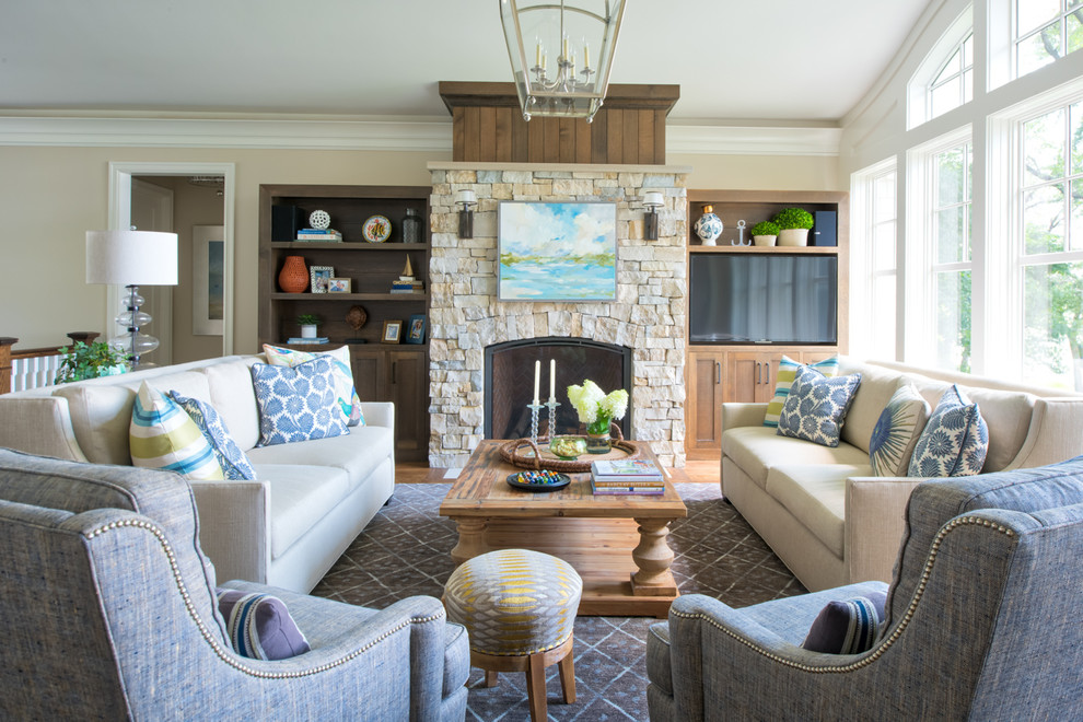 Design ideas for a large beach style open concept family room in Minneapolis with grey walls, medium hardwood floors, a standard fireplace, a stone fireplace surround and brown floor.