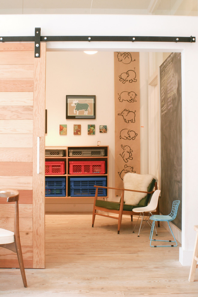 Contemporary toddler room in San Francisco with light hardwood floors.