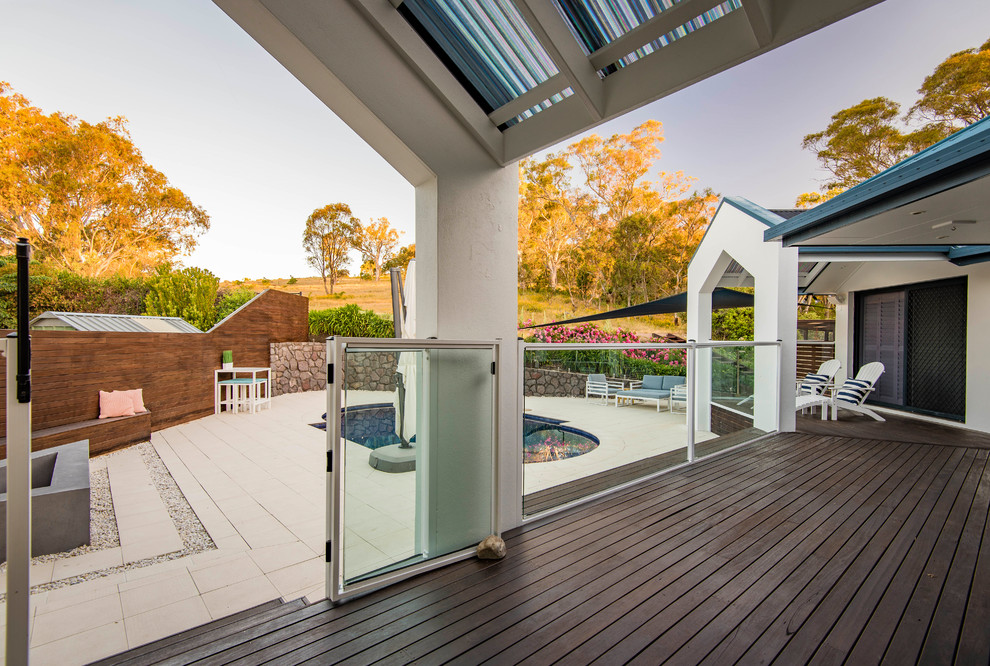 Design ideas for a large contemporary backyard deck in Canberra - Queanbeyan with a pergola.