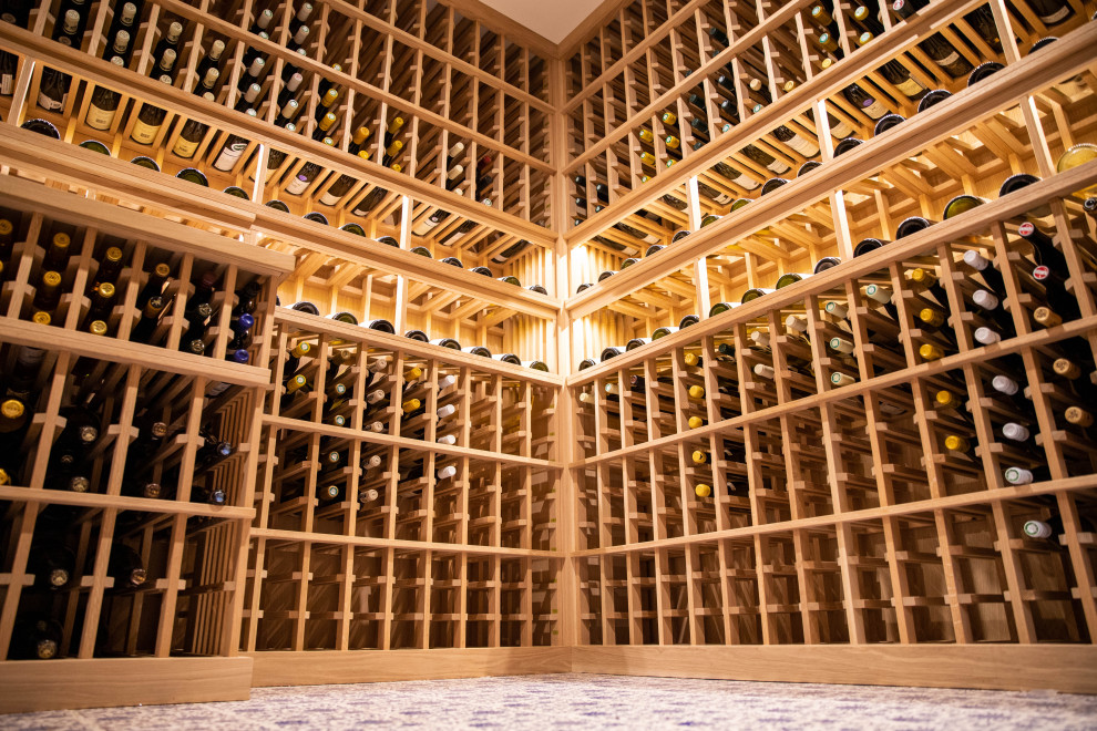 Design ideas for a mid-sized traditional wine cellar in Orange County with porcelain floors, storage racks and blue floor.