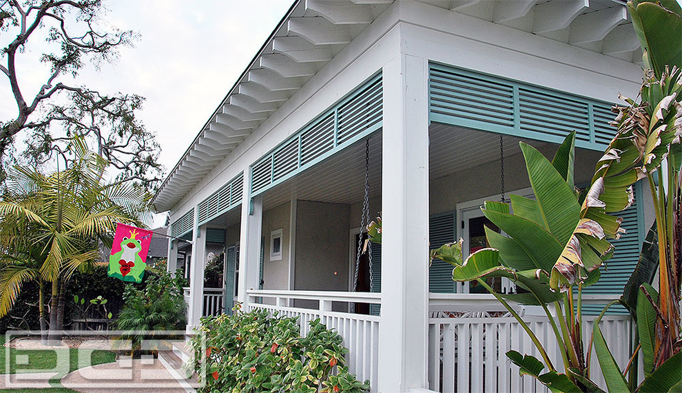 Custom-Made Louvered Shutters in a Pastel Green Finish  for an Outdoor Porch
