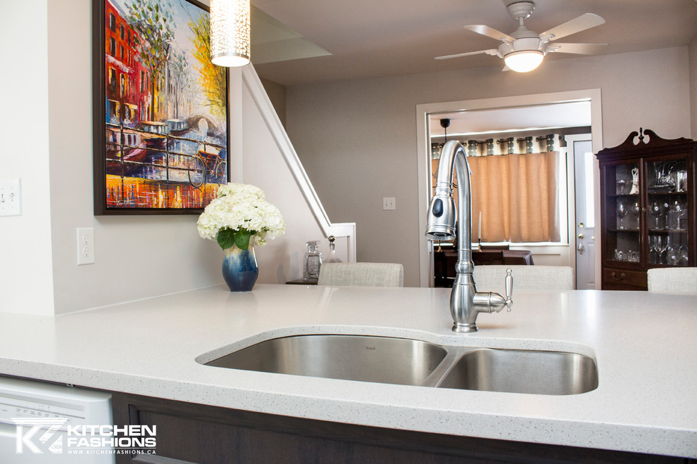 Mid-sized transitional single-wall ceramic tile open concept kitchen photo with an undermount sink, shaker cabinets, gray cabinets, solid surface countertops, gray backsplash, mosaic tile backsplash, white appliances and an island