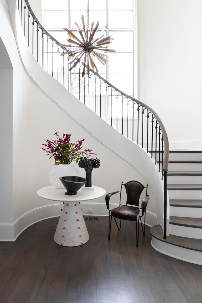 This is an example of a mediterranean wood staircase in Charlotte with painted wood risers.