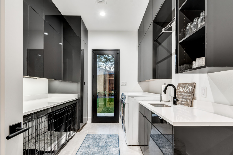 Photo of a large modern u-shaped dedicated laundry room in Dallas with an undermount sink, flat-panel cabinets, grey cabinets, quartz benchtops, white walls, porcelain floors, a side-by-side washer and dryer, grey floor and white benchtop.