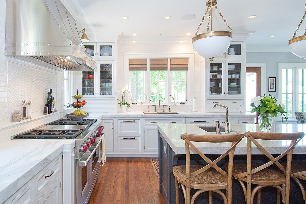 Inspiration for a traditional kitchen in Chicago with shaker cabinets, white cabinets, white splashback, subway tile splashback, stainless steel appliances and quartzite benchtops.