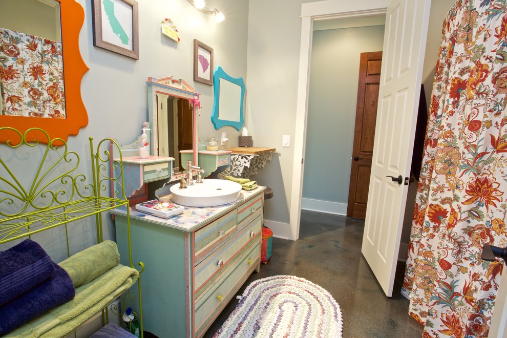 Huge transitional kids' concrete floor tub/shower combo photo with a vessel sink, distressed cabinets, wood countertops and beige walls