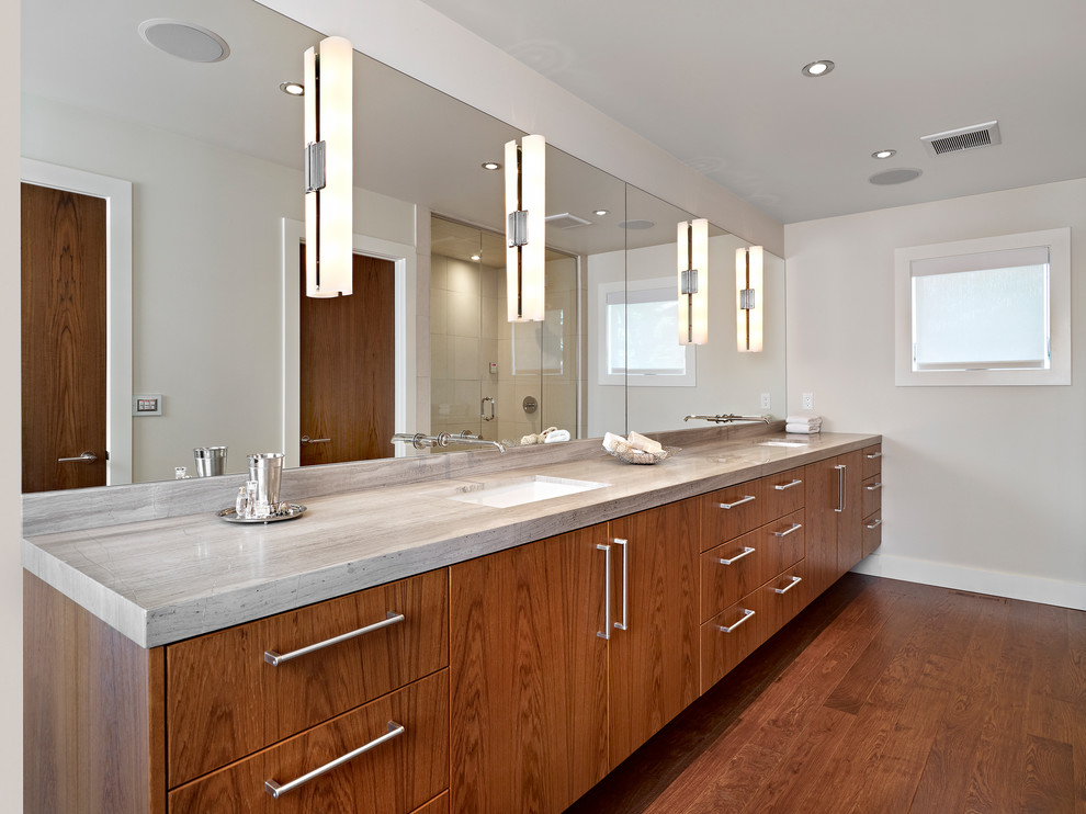 This is an example of a contemporary master bathroom in Edmonton with flat-panel cabinets, medium wood cabinets and grey benchtops.