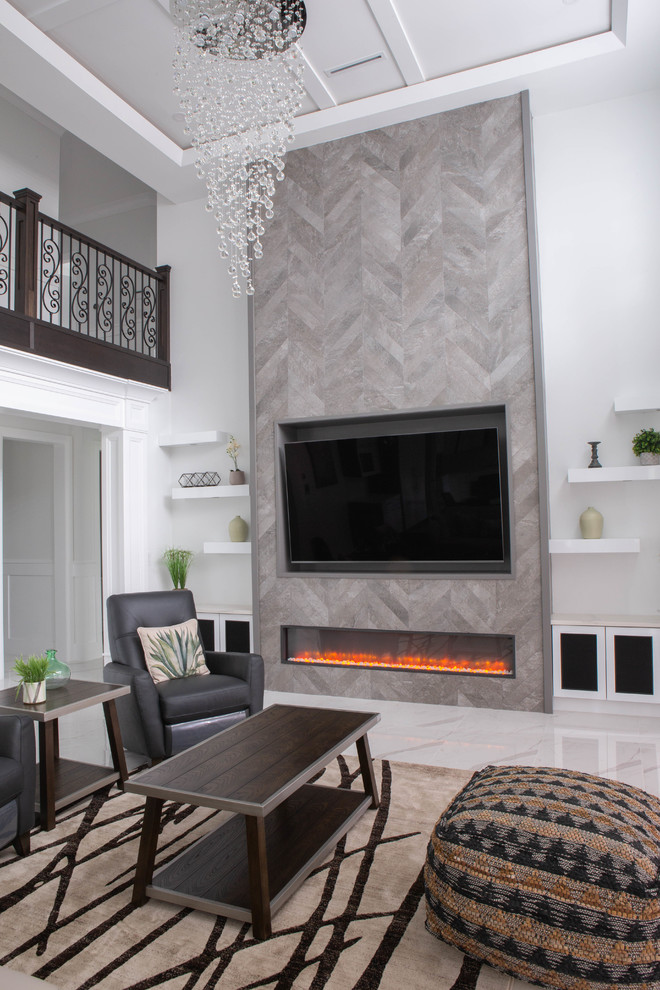Inspiration for a large contemporary enclosed family room in Vancouver with white walls, marble floors, a ribbon fireplace, a tile fireplace surround, a wall-mounted tv and white floor.