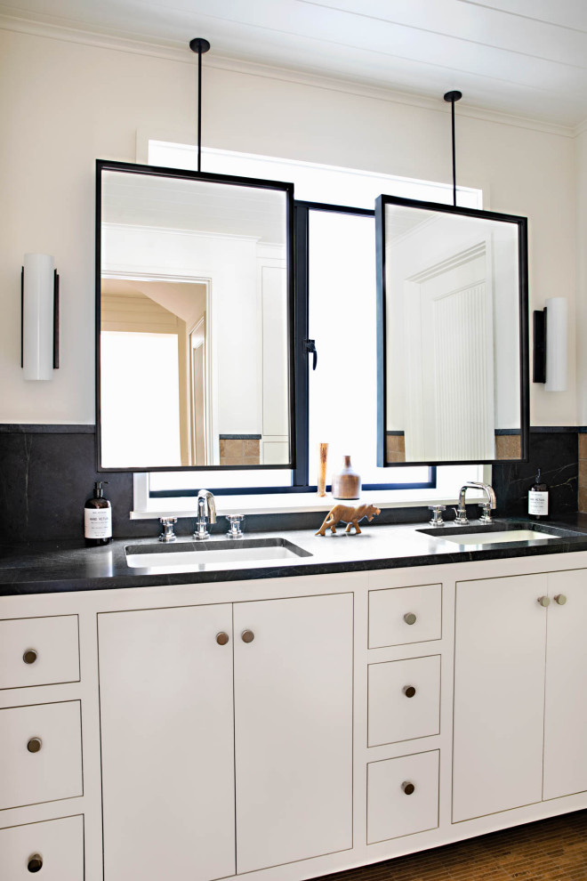 Photo of a beach style bathroom in San Diego with flat-panel cabinets, white cabinets, an undermount sink, marble benchtops, black benchtops, a double vanity, a freestanding vanity and timber.