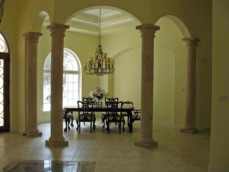 Inspiration for a large porcelain tile great room remodel with yellow walls and no fireplace