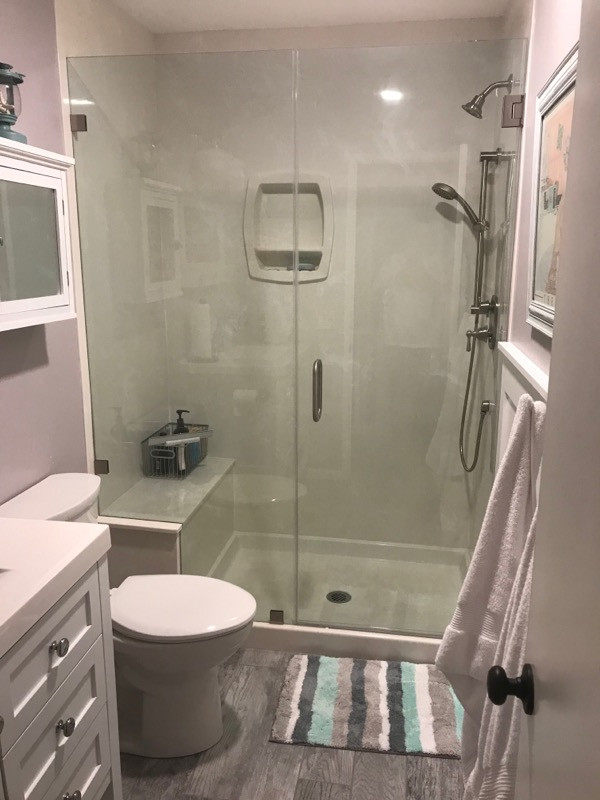Mid-sized beach style 3/4 single-sink, plywood floor and gray floor bathroom photo in Orange County with recessed-panel cabinets, white cabinets, quartzite countertops, yellow countertops, a freestanding vanity, a one-piece toilet, purple walls, a drop-in sink and a hinged shower door
