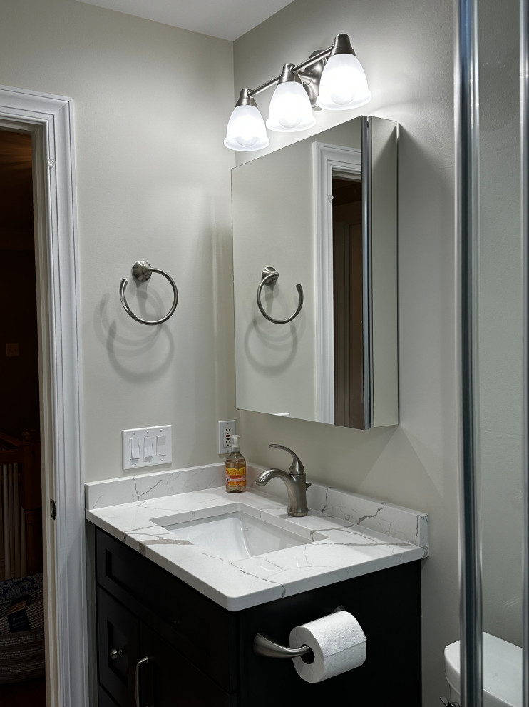 Small transitional kids' blue tile and ceramic tile porcelain tile, beige floor and single-sink bathroom photo in DC Metro with flat-panel cabinets, gray cabinets, a two-piece toilet, white walls, an undermount sink, quartz countertops, white countertops, a niche and a built-in vanity