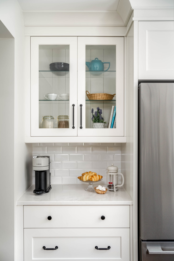 Inspiration for a large transitional l-shaped kitchen remodel in Toronto with shaker cabinets and an island