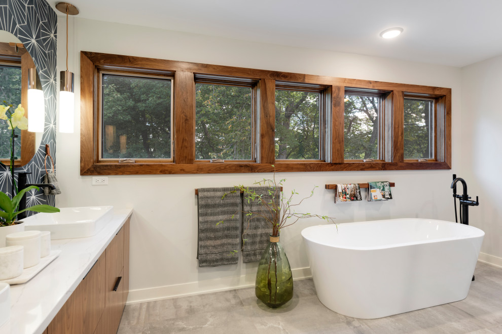 Large midcentury master bathroom in Minneapolis with flat-panel cabinets, dark wood cabinets, a japanese tub, a corner shower, a two-piece toilet, blue tile, porcelain tile, white walls, porcelain floors, an undermount sink, quartzite benchtops, grey floor, a hinged shower door, white benchtops, an enclosed toilet, a double vanity and a freestanding vanity.
