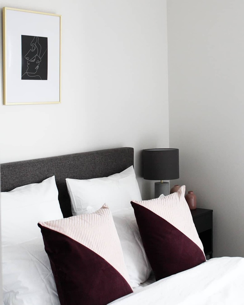Mid-sized contemporary guest bedroom in Melbourne with white walls, carpet, no fireplace and grey floor.