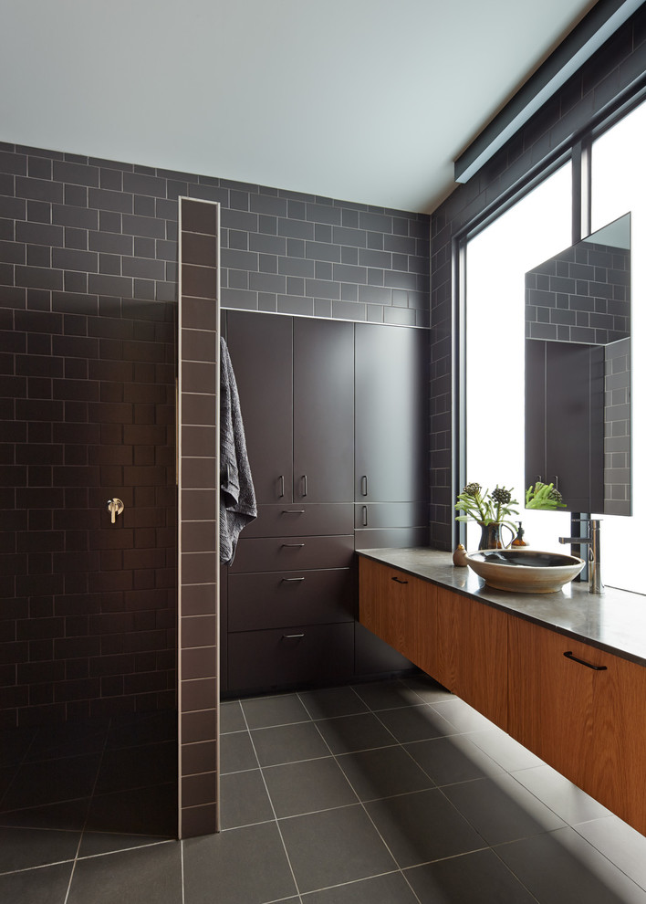 Design ideas for a contemporary bathroom in Melbourne with medium wood cabinets, limestone benchtops, an alcove shower, gray tile and ceramic tile.