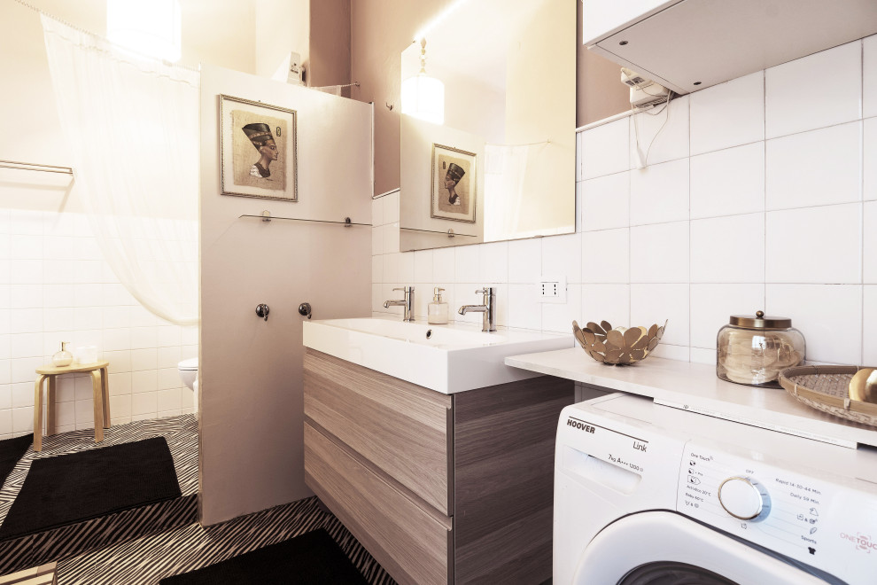 This is an example of a medium sized eclectic shower room bathroom in Milan with flat-panel cabinets, beige cabinets, a corner shower, a bidet, white tiles, cement tiles, pink walls, lino flooring, an integrated sink, multi-coloured floors, a shower curtain, a shower bench, double sinks and a floating vanity unit.