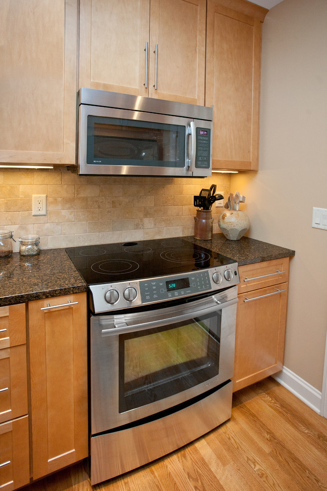 Example of a small transitional galley medium tone wood floor eat-in kitchen design with an undermount sink, recessed-panel cabinets, light wood cabinets, quartz countertops, beige backsplash, stone tile backsplash, white appliances, beige walls and no island