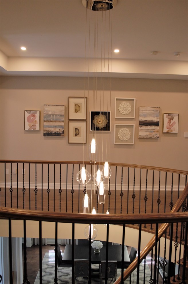 Large transitional medium tone wood floor and brown floor hallway photo in Toronto with gray walls