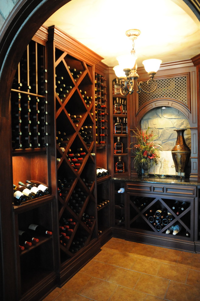 This is an example of a mid-sized traditional wine cellar in Louisville with ceramic floors, diamond bins and yellow floor.