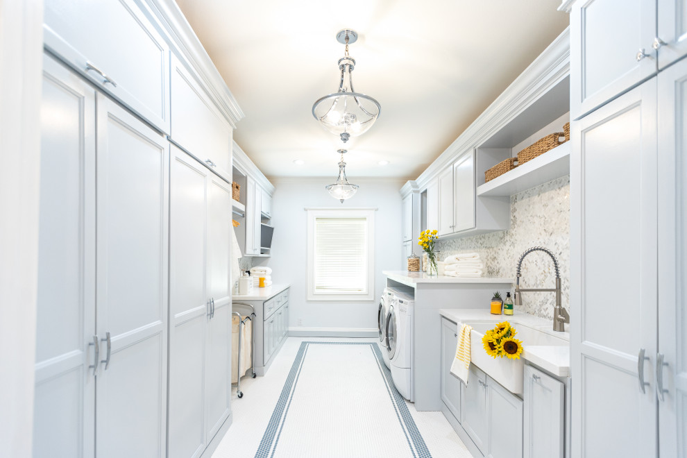 Inspiration for a contemporary laundry room in Tampa with a farmhouse sink, shaker cabinets, blue cabinets, quartzite benchtops, multi-coloured splashback, marble splashback, blue walls, porcelain floors and white floor.