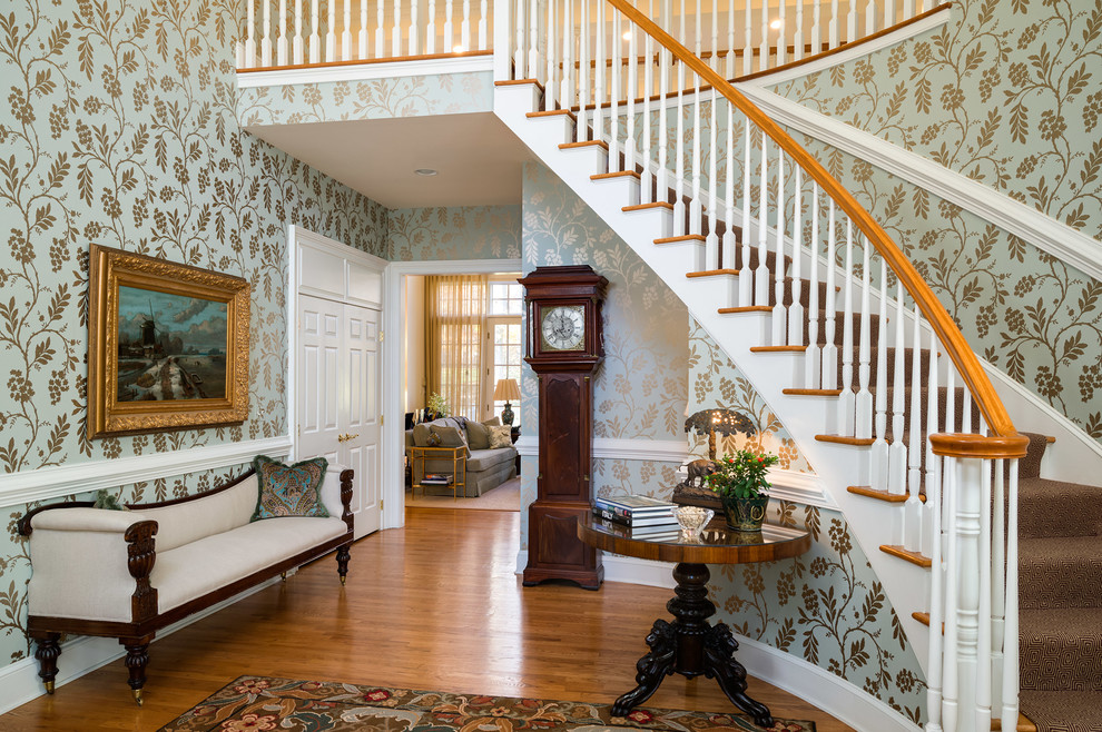 Inspiration for a traditional foyer in New York with multi-coloured walls and medium hardwood floors.