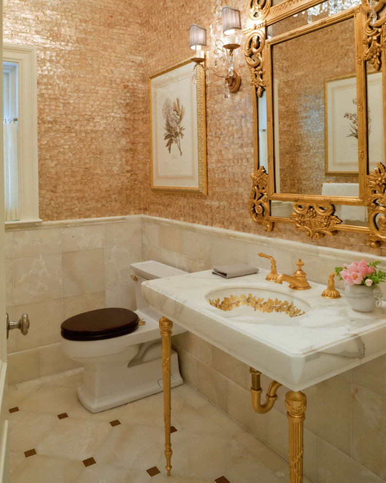 Mid-sized traditional powder room in Boston with a one-piece toilet, multi-coloured walls, beige floor, a console sink, marble, marble benchtops and marble floors.