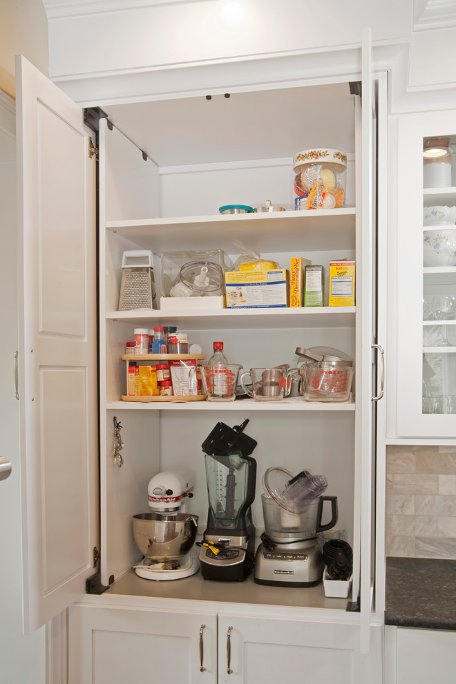 Eat-in kitchen - large transitional l-shaped medium tone wood floor eat-in kitchen idea in Philadelphia with a farmhouse sink, shaker cabinets, white cabinets, granite countertops, gray backsplash, stone tile backsplash, stainless steel appliances and an island