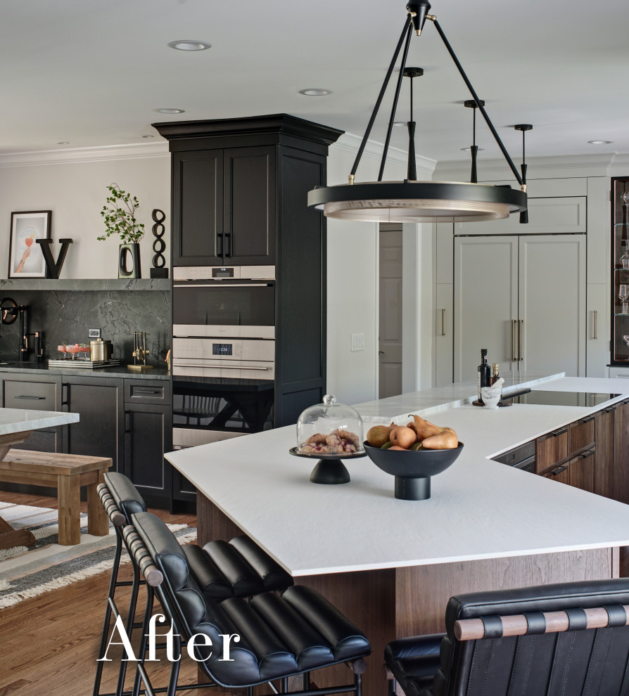 Example of a large transitional l-shaped medium tone wood floor and brown floor eat-in kitchen design in Chicago with an undermount sink, flat-panel cabinets, white cabinets, solid surface countertops, white backsplash, marble backsplash, paneled appliances, an island and black countertops