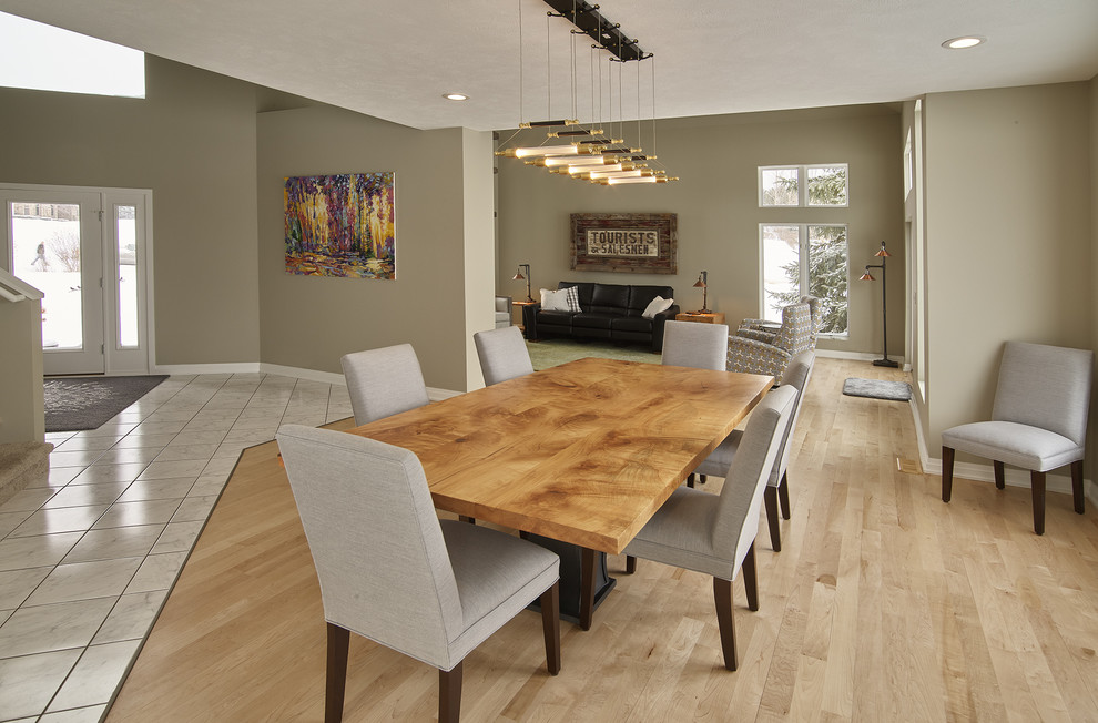 Large eclectic dining room in Other with grey walls and light hardwood floors.