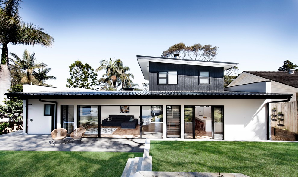 Inspiration for a beach style two-storey white house exterior in Melbourne.