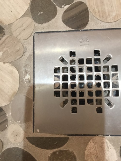 Grout around shower drain?